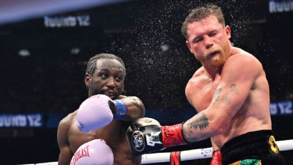 Terence Crawford and Canelo Alvarez face off in a boxing ring.