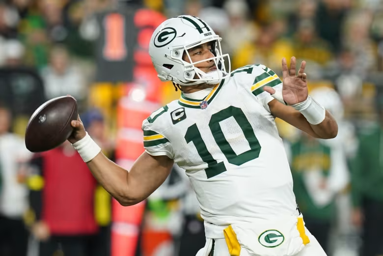 Jordan Love celebrating after a clutch throw during the Green Bay Packers vs. Pittsburgh Steelers game.
